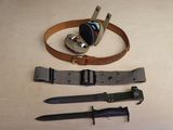 a knife, belt, and other items on a table