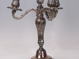 silver plated candelabra with three candles on a stand
