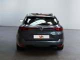 a grey car parked in a room with a white wall
