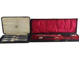 un coffret noir contenant de l'argenterie, sur fond blanc