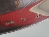 a close up of a silver spoon with numbers on it