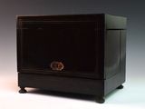 a small black cabinet with a drawer on top of it