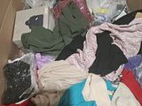 a cardboard box filled with clothes and other items