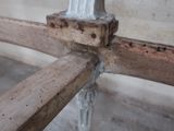 a close up of a metal pipe on a wooden pole
