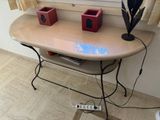 a table with a lamp and a remote control on it