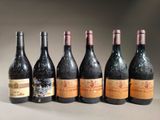 six bottles of wine are lined up in a row on a table
