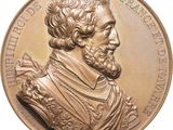une image représentant une médaille de bronze à l'effigie d'un homme barbu et moustachu