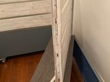 a bed with a wooden headboard and a metal bed frame