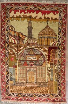 an old rug with a picture of a building on it