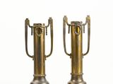 two metal vases that have handles on them