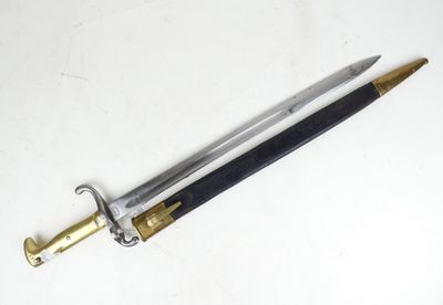 a close up of a sword on a white surface with a black handle
