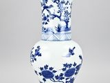 blue and white vase with birds and flowers in a landscape
