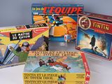 several children ' s board games are sitting on a white surface