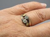 a person ' s hand with a ring on it