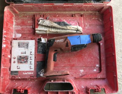 a red tool box with tools in it on the floor