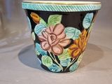 a close up of a flower pot on a table