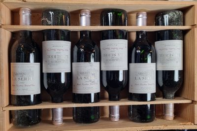 many bottles of wine sitting in a wooden case