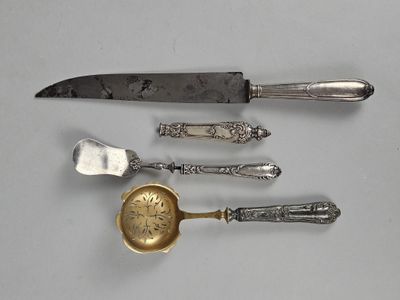 a knife, spoon, and spoon rest on a table