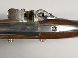 a close up of a gun on a white surface