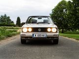 a car that is driving down the road with headlights on
