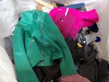 a pile of clothes in a plastic bag on the floor