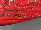a red bandanna with a picture of a cow on it
