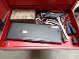 a red tool box with tools in it on the floor