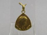 an image of a gold pendant with a picture of a woman on it