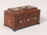 an antique wooden box with a lion head on top of it