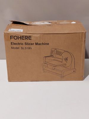 une trancheuse électrique posée sur un carton