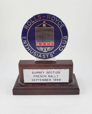 a picture of a blue and white sign on a wooden base