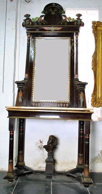 a mirror sitting on a table next to a mirror on the wall