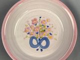a small plate with a flower design on it