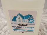 a close up of a bottle of vinegar cleaner on a table