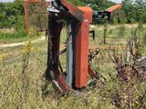 a rusted out car in the middle of a field
