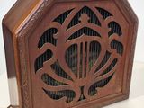 une vieille radio en bois surmontée d'un oiseau