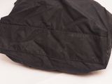 a black hat that is sitting on a white surface