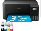 the printer is sitting next to the ink cartridges and ink bottles