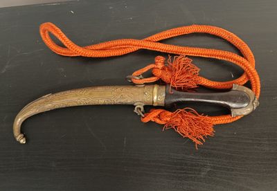 an old knife with a long handle on a table