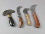 four different types of knives are lined up on a white surface