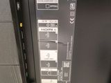 the back panel of a sony laptop with a lot of stickers on it