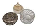 a small glass container with a lid and a small glass container with a lid