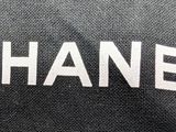 black and white photograph of a chanel bag with the word chanel written on it