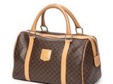 a brown and tan handbag on a white background