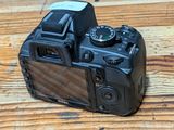 a camera sitting on a wooden table on a table
