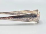 a close up of a silver spoon with a red handle