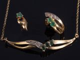 an image of a gold necklace and earring set with emerald stones