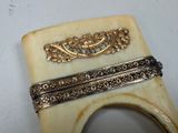 a piece of jewelry that is sitting on top of a piece of horn