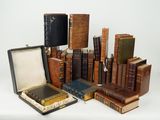 many old books stacked on top of each other