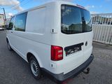 the back end of a white van parked in a parking lot